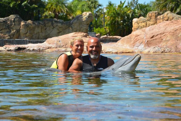 A man and woman swimming in the water.